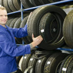 man-in-the-tire-store-with-a-tire